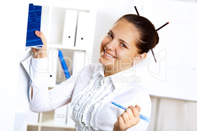 Young beautiful woman in business wear at work