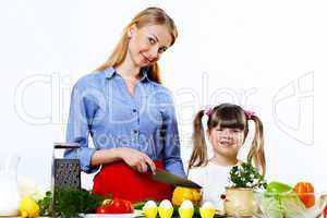 Young mother cooking at home with her daoghter