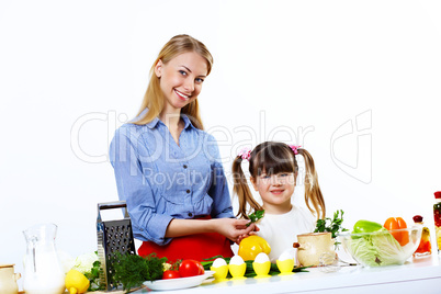 Young mother cooking at home with her daoghter