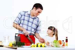 family with a daughter cooking together at home