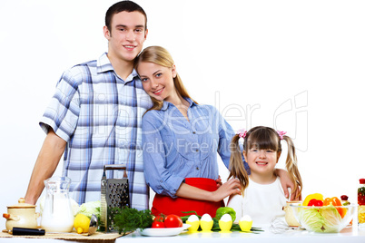 family with a daughter cooking together at home