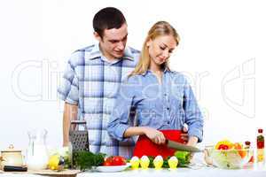 Husband and wife together coooking at home