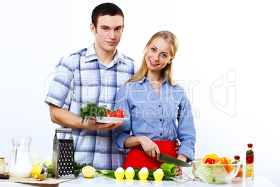 Husband and wife together coooking at home