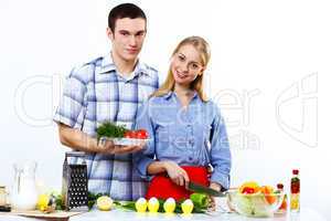 Husband and wife together coooking at home