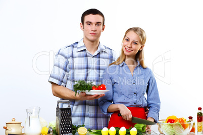 Husband and wife together coooking at home