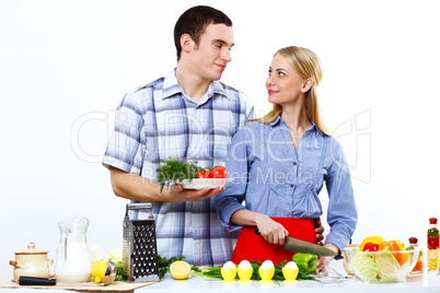 Husband and wife together coooking at home