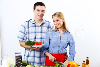 Husband and wife together coooking at home