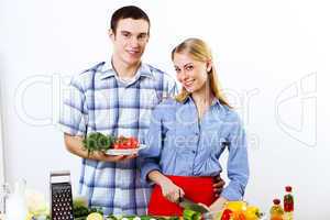 Husband and wife together coooking at home