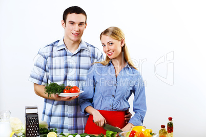 Husband and wife together coooking at home