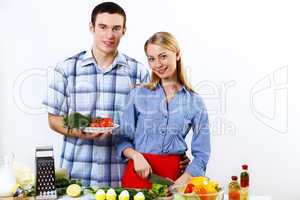 Husband and wife together coooking at home