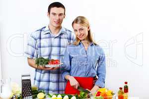 Husband and wife together coooking at home