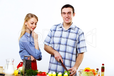 Husband and wife together coooking at home