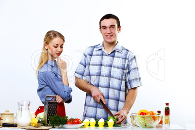 Husband and wife together coooking at home