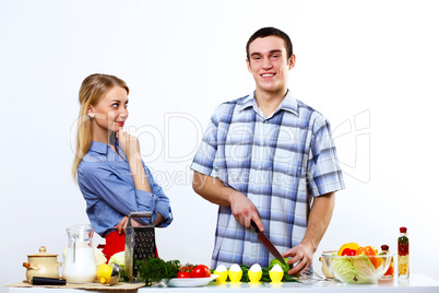 Husband and wife together coooking at home