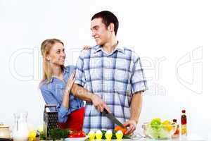 Husband and wife together coooking at home