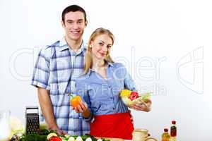 Husband and wife together coooking at home