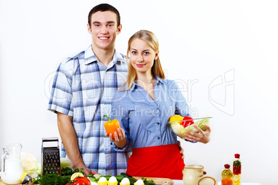 Husband and wife together coooking at home