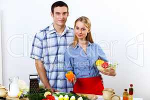 Husband and wife together coooking at home