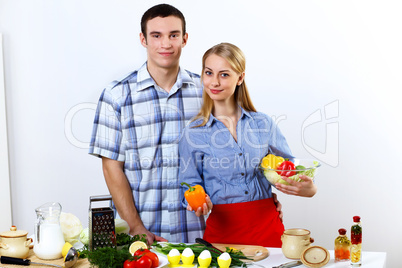 Husband and wife together coooking at home