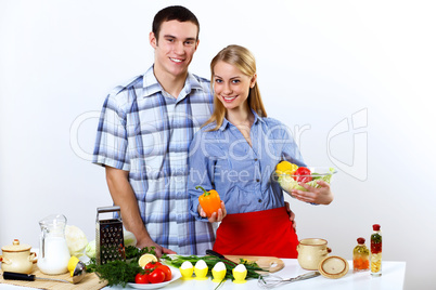 Husband and wife together coooking at home