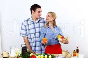 Husband and wife together coooking at home