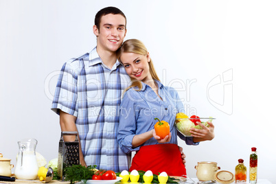 Husband and wife together coooking at home