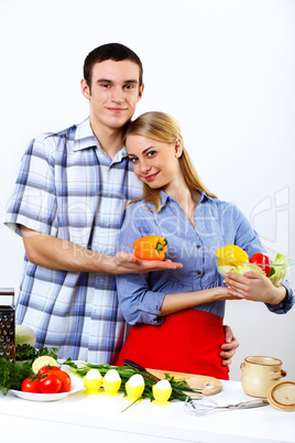 Husband and wife together coooking at home