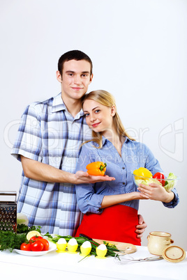 Husband and wife together coooking at home