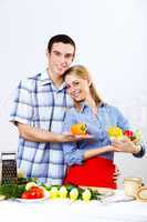 Husband and wife together coooking at home