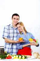 Husband and wife together coooking at home