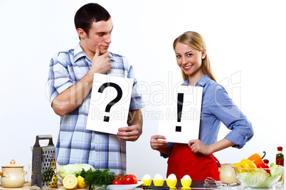 Husband and wife together coooking at home