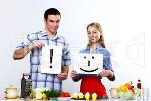 Husband and wife together coooking at home