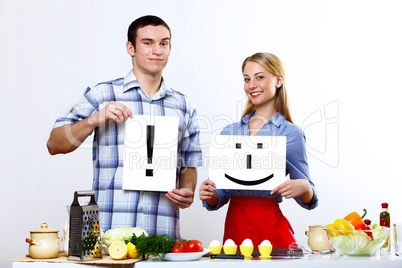 Husband and wife together coooking at home