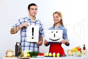 Husband and wife together coooking at home