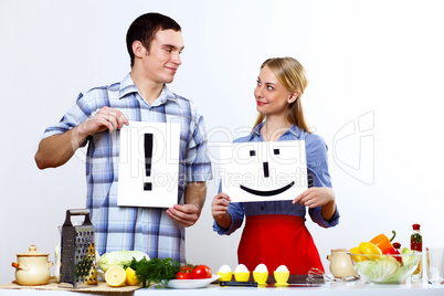 Husband and wife together coooking at home