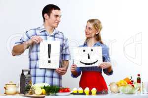 Husband and wife together coooking at home