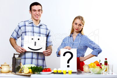 Husband and wife together coooking at home