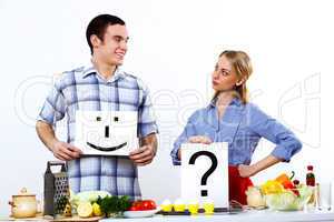 Husband and wife together coooking at home