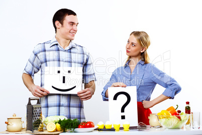 Husband and wife together coooking at home