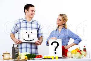 Husband and wife together coooking at home