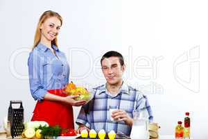 Husband and wife together coooking at home