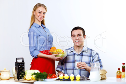 Husband and wife together coooking at home