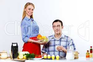 Husband and wife together coooking at home