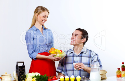 Husband and wife together coooking at home