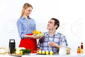 Husband and wife together coooking at home