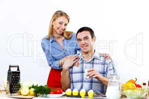 Husband and wife together coooking at home