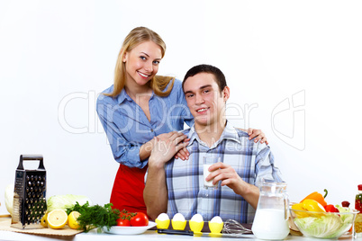 Husband and wife together coooking at home