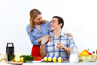 Husband and wife together coooking at home