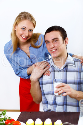 Husband and wife together coooking at home