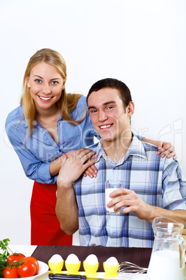 Husband and wife together coooking at home